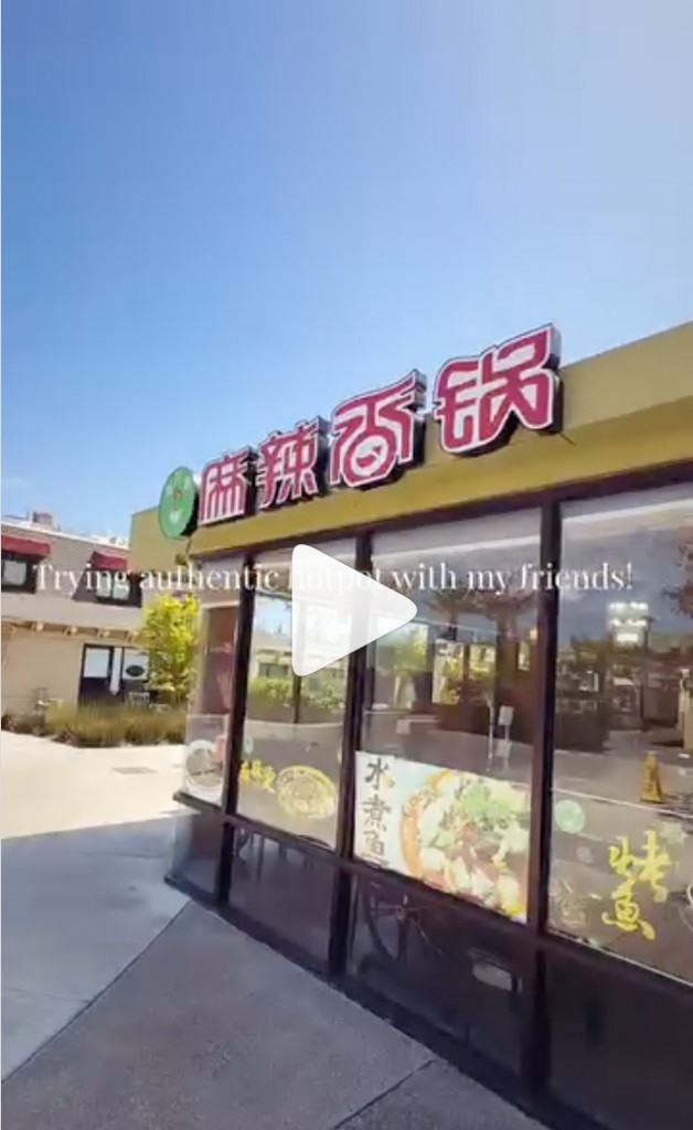 Reel still: trying authentic hotpot with friends outside a Chinese restaurant with Mala Xiang Guo signage