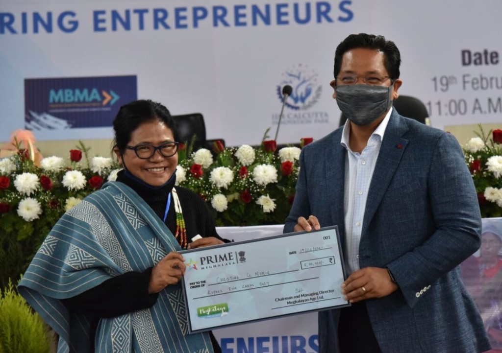 Christine G. Momin receiving a ceremonial PRIME Meghalaya cheque for five lakhs at an entrepreneurship event, 19 February 2021